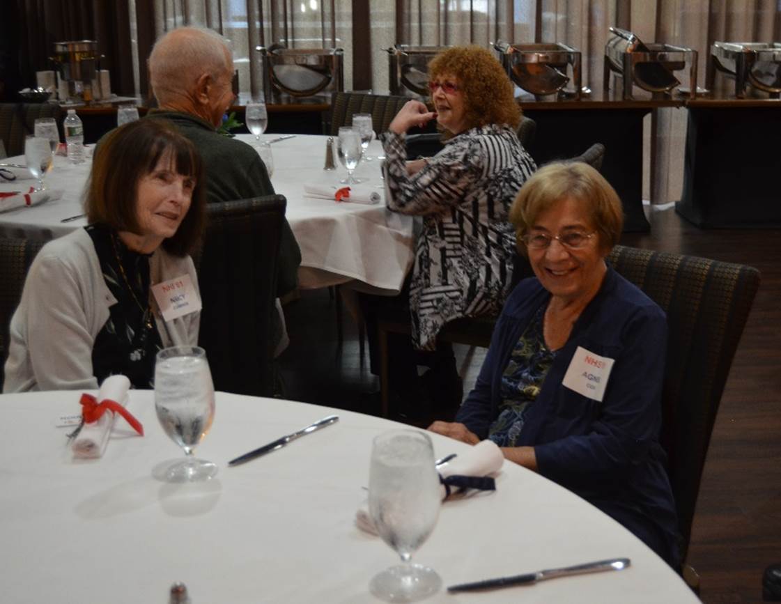 A group of women sitting at a table

Description automatically generated