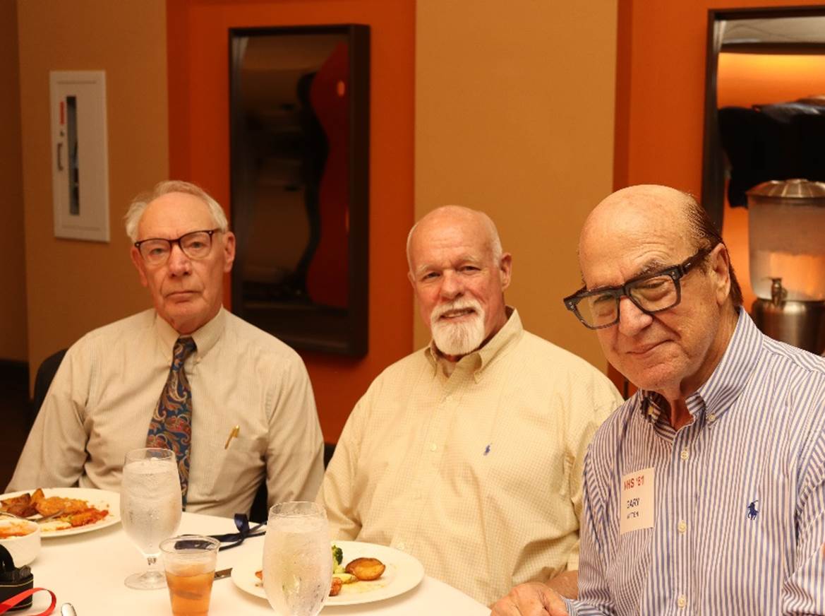 A group of men sitting at a table

Description automatically generated