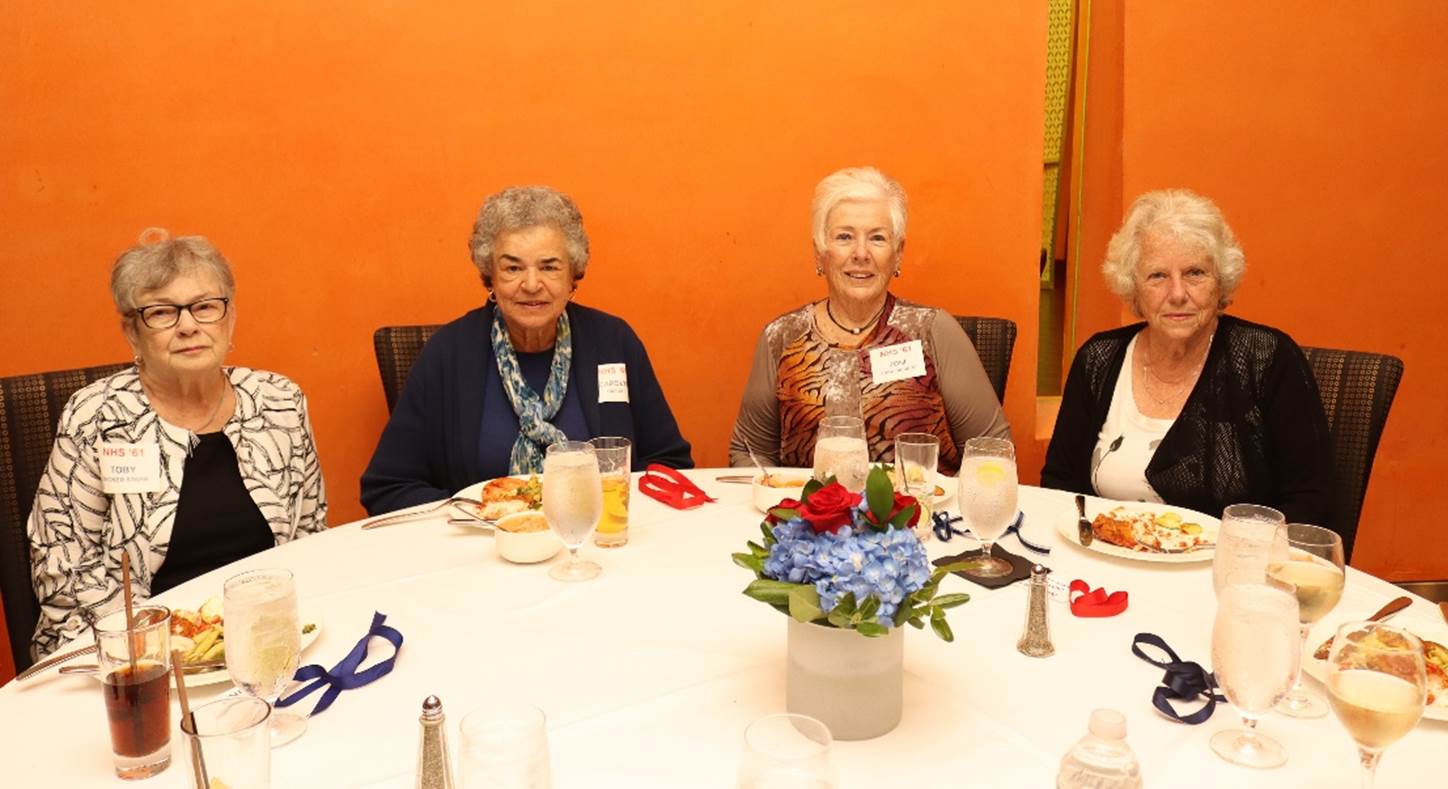 A group of women sitting at a table

Description automatically generated